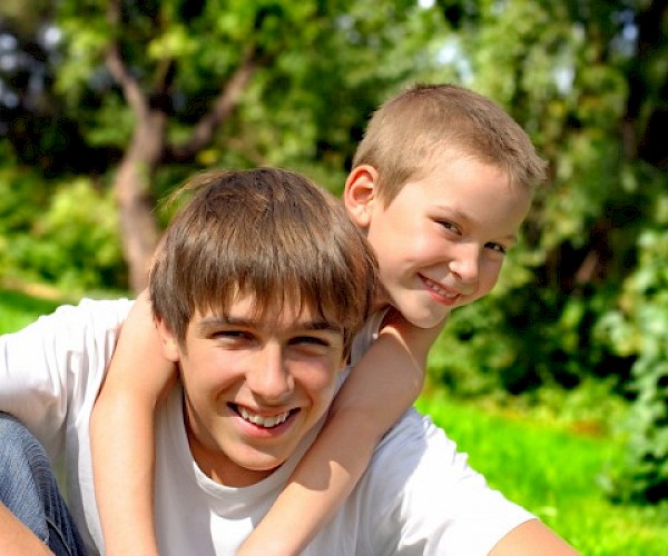 Older boys hugging outside