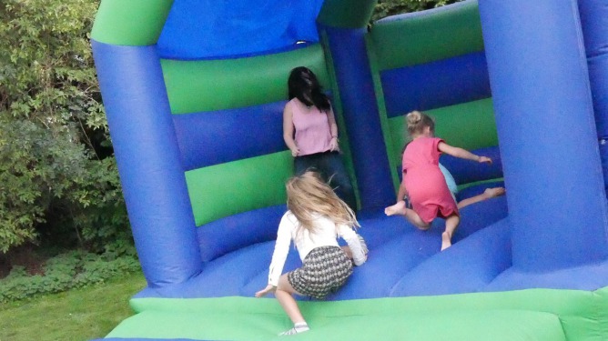 Children adopted through Diagrama playing on bouncy castle with social worker